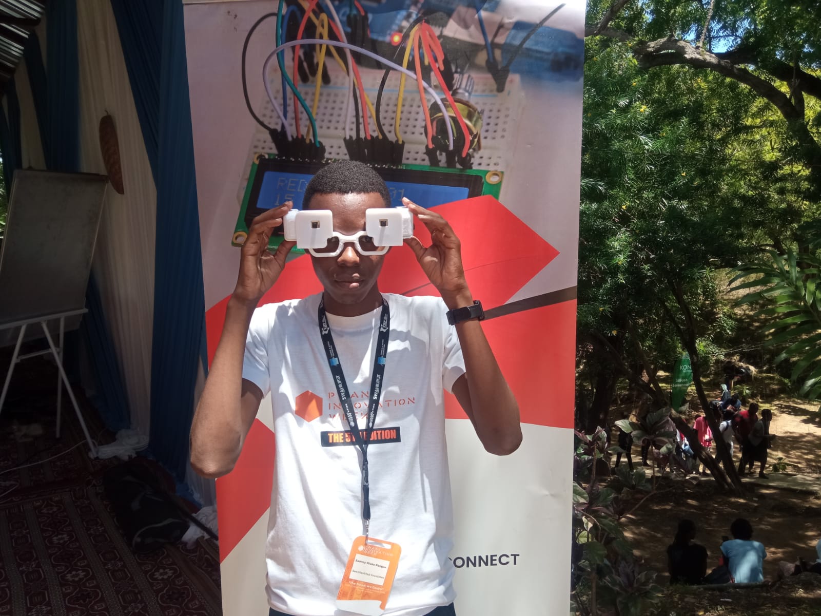 Student wearing a 3D-printed smart glasses prototype at an innovation week